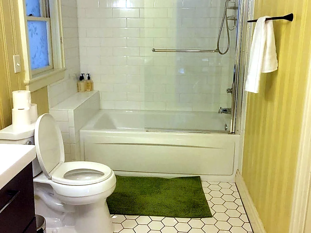 Clean white bathroom with bathtub